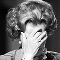 British prime minister Margaret Thatcher covering her face with her hand at the 1985 Conservative Party Conference.jpg